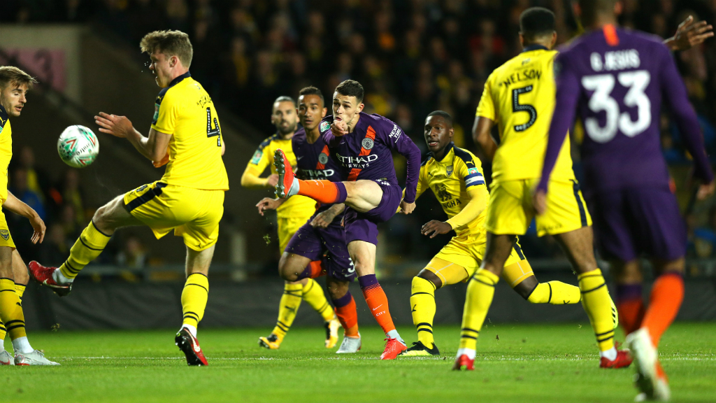 BOY BLUE: Phil Foden goes in search of his first City goal - but his volley is deflected wide