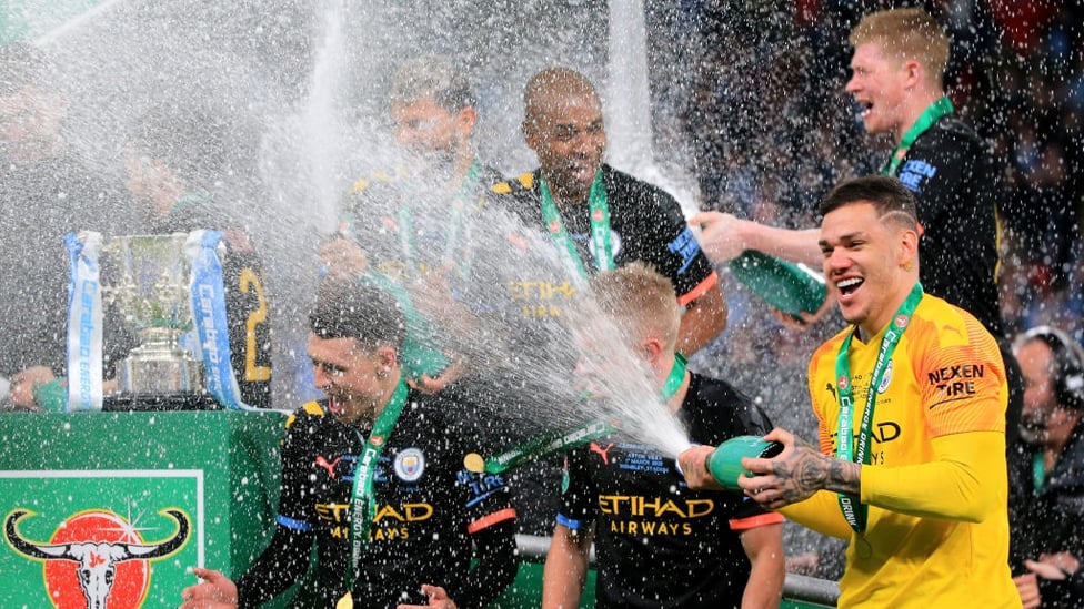 SAFE HANDS : Ederson showers Foden in some champagne.