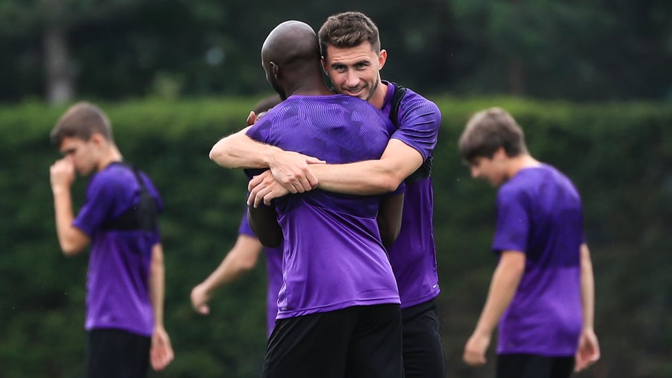 FRENCH CONNECTION : Aymeric Laporte and Eliquim Mangala embrace as they take a quick breather from training
