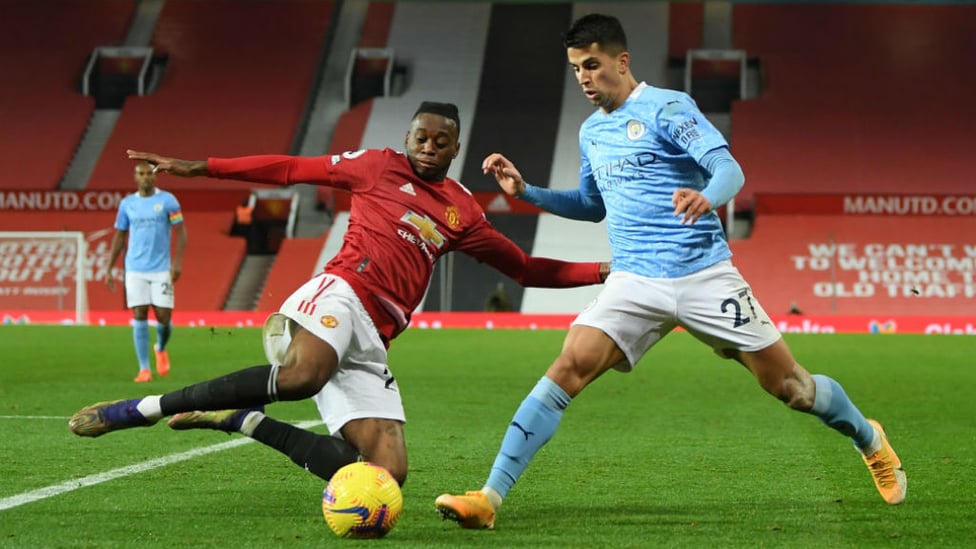 AT FULL STRETCH: Wan-Bissaka and Cancelo vie for possession