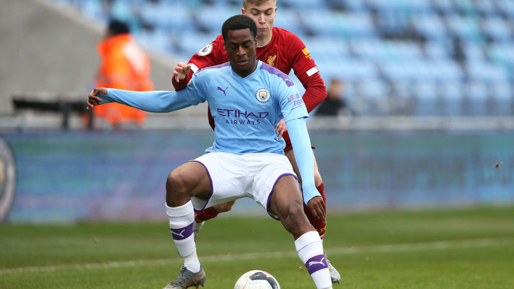 BATTLE: Ogbeta is challenged for the ball at the Academy Stadium.