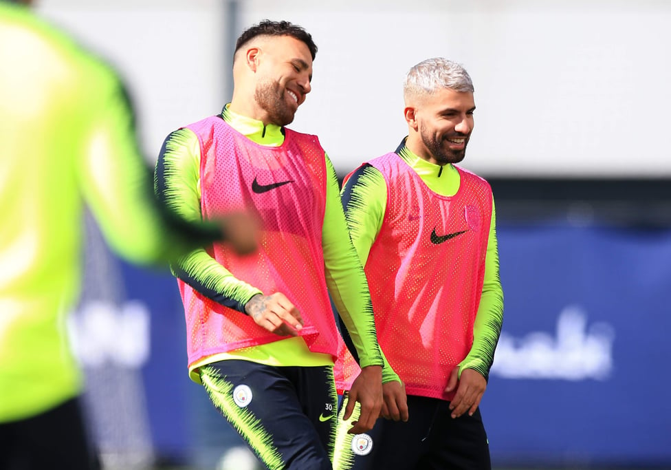 PRETTY IN PINK : Sergio Aguero and Nicolas Otamendi take to the training pitches