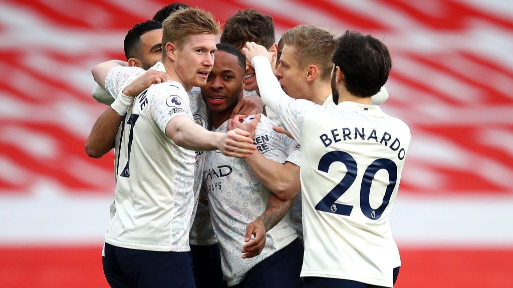 GROUP HUG: The players gather to share the love after Sterling's accurate header.