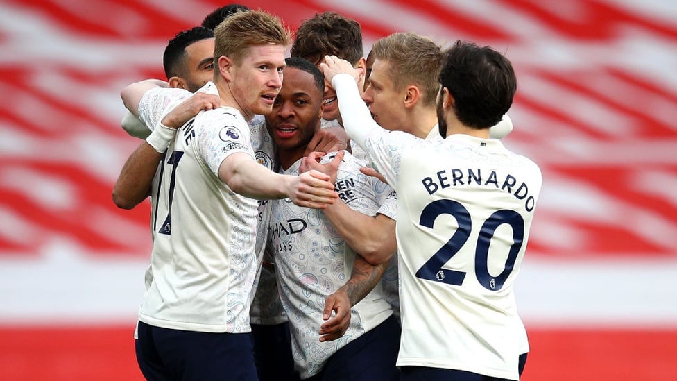 GROUP HUG : The players gather to share the love after Sterling's accurate header.