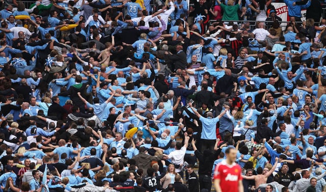 Man City fans doing the Poznan during the Manchester Derby