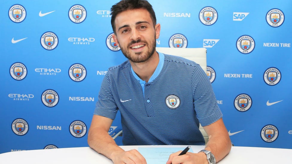 TRUE BLUE : Bernardo is all smiles after signing for City in the summer of 2017