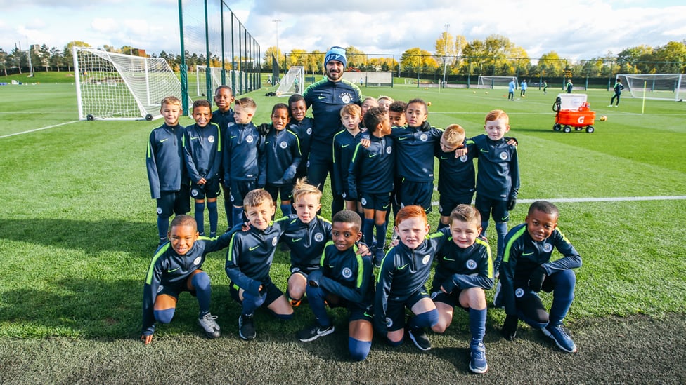 SQUAD : Our Under-8s pose for a picture with Ilkay Gundogan.