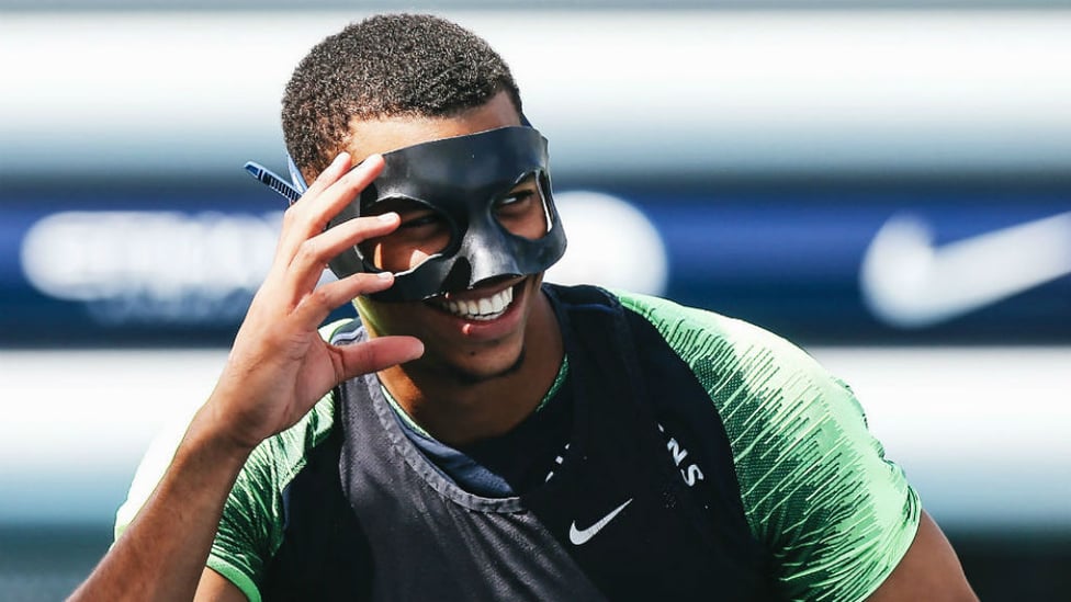 MASKED BALL : Lukas Nmecha has some fun and games with Ilkay Gundogan's protective mask