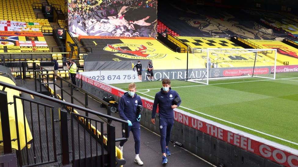 ARRIVAL : De Bruyne and Stones arrive at Vicarage Road.