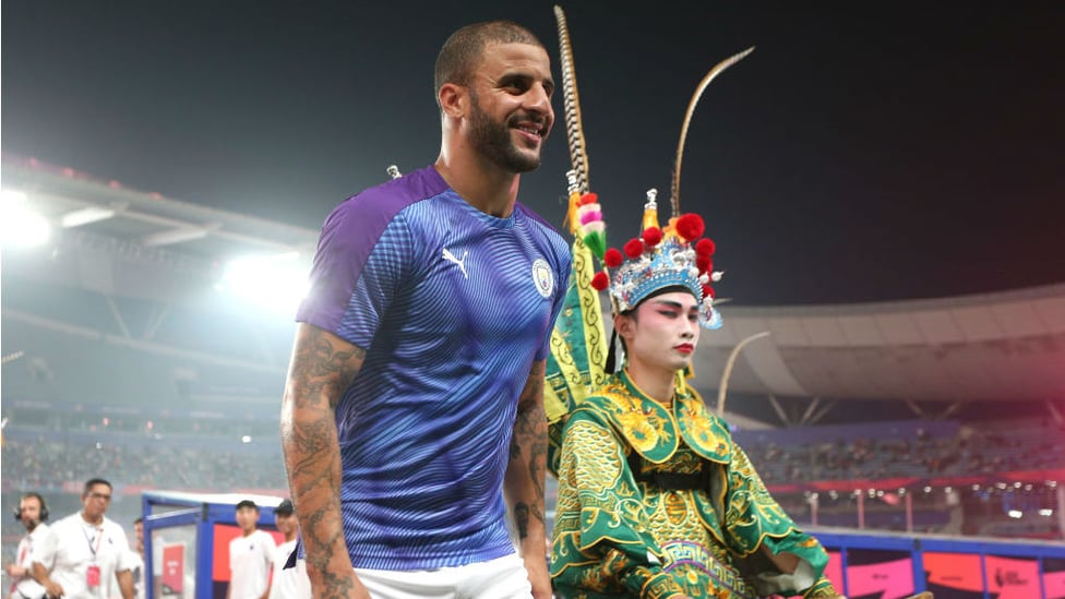 DRESSED TO IMPRESS : Kyle Walker and a entertainer dressed in colourful traditional Chinese dress