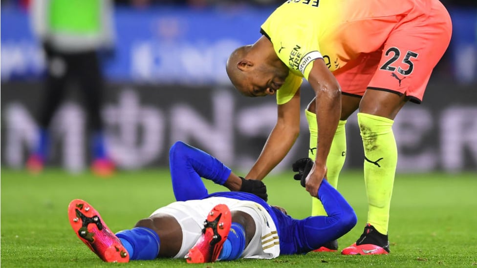 OUCH: Fernandinho checks on Kelechi Iheanacho after the striker was laid low by a collision with Ederson