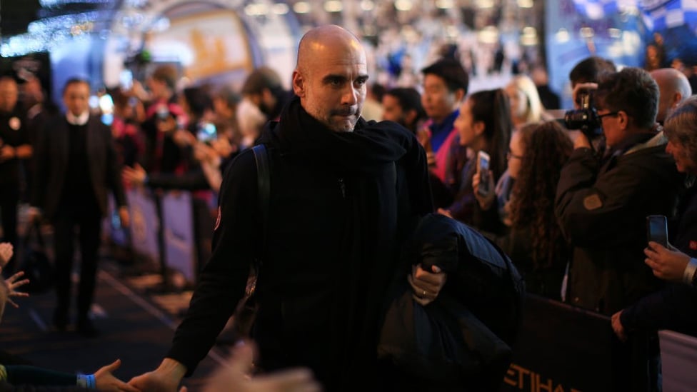 THE BOSS : Pep Guardiola checks in at the Etihad.