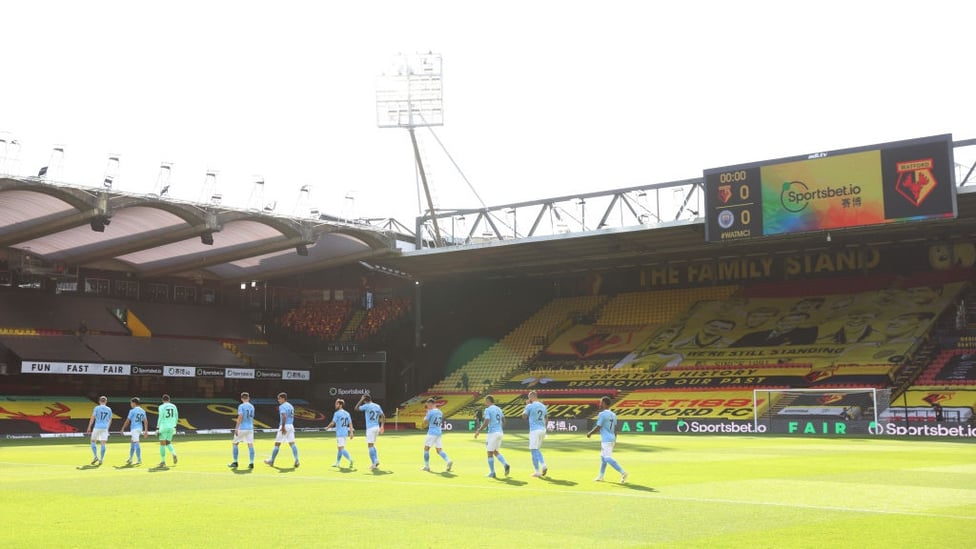 SQUAD GOALS : The starting team make their way onto the sun-covered pitch.