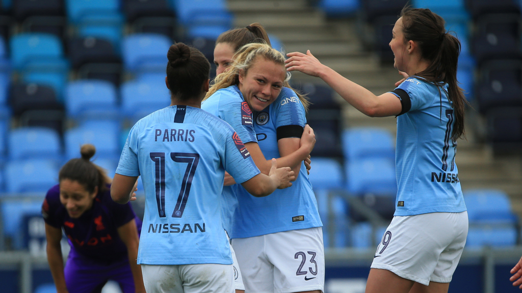 CELEBRATION TIME : Claire Emslie is greeted by her City team-mates after her first-half strike