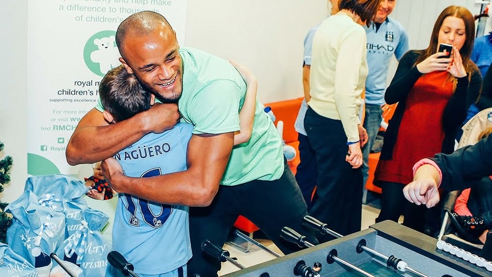 LITTLE AND LARGE : Kompany hugs a young fan while on hospital visit.