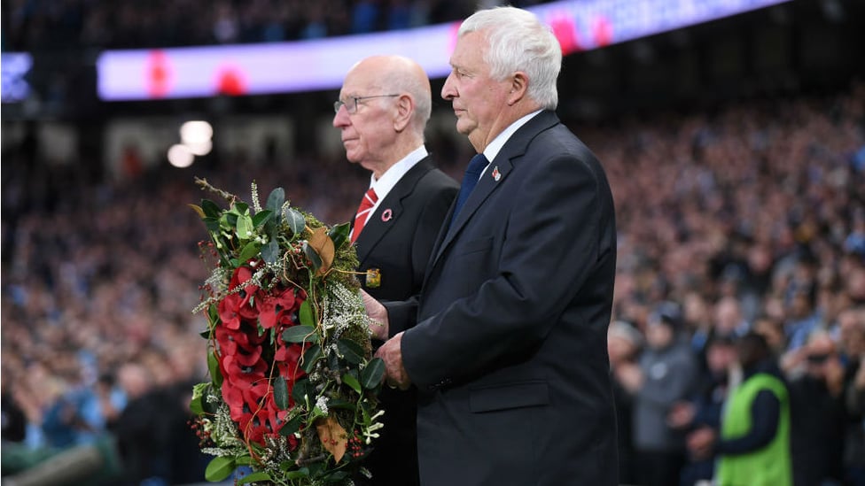 POIGNANT : Mike Summerbee and Sir Bobby Charlton laid a wreath before kick-off to honour the fallen