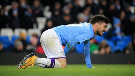 KNOCK: David Silva grimaces after a robust challenge from Angelo Ogbonna.