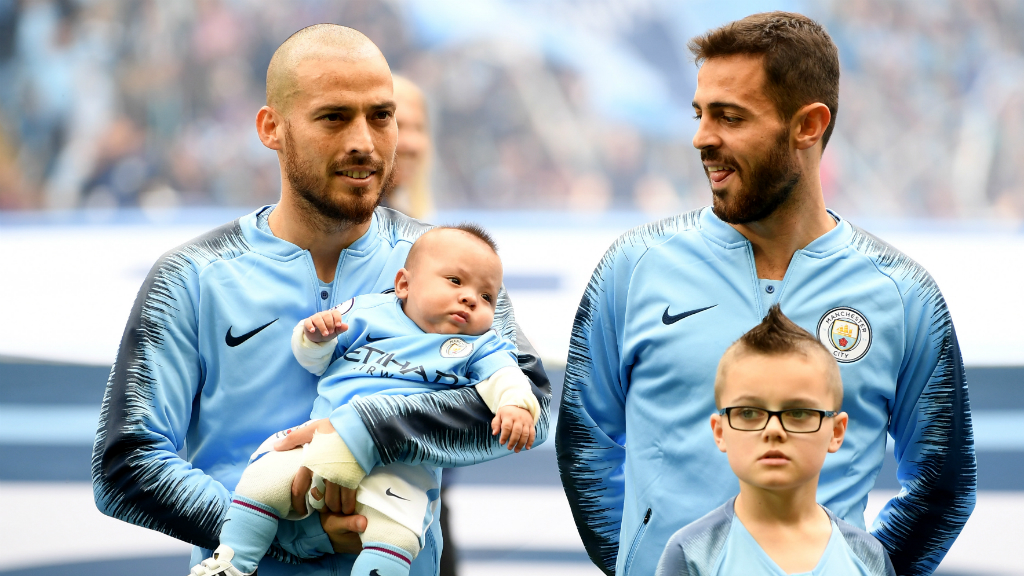 LITTLE BOY BLUE : David Silva cradles his son Mateo before kick-off