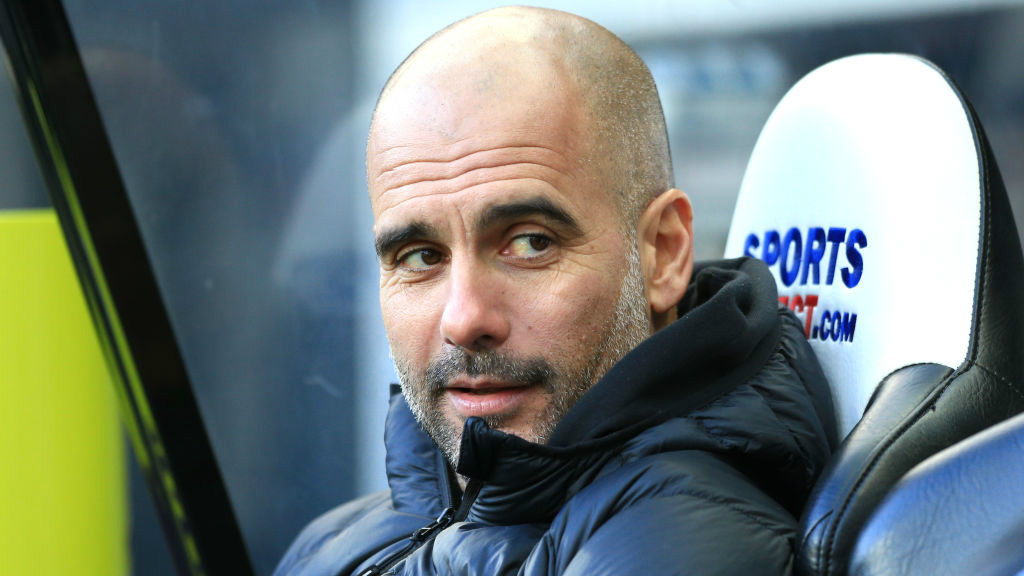 PRE-MATCH: Pep Guardiola takes his seat in the dugout.