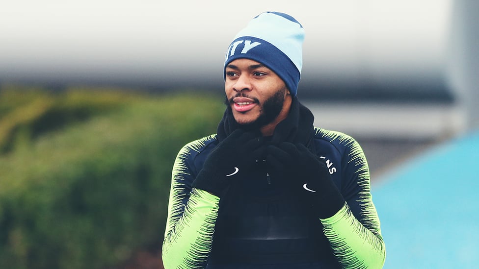 CALL OF DUTY : Raheem Sterling is kitted out to keep out the chill as he heads to the training pitch