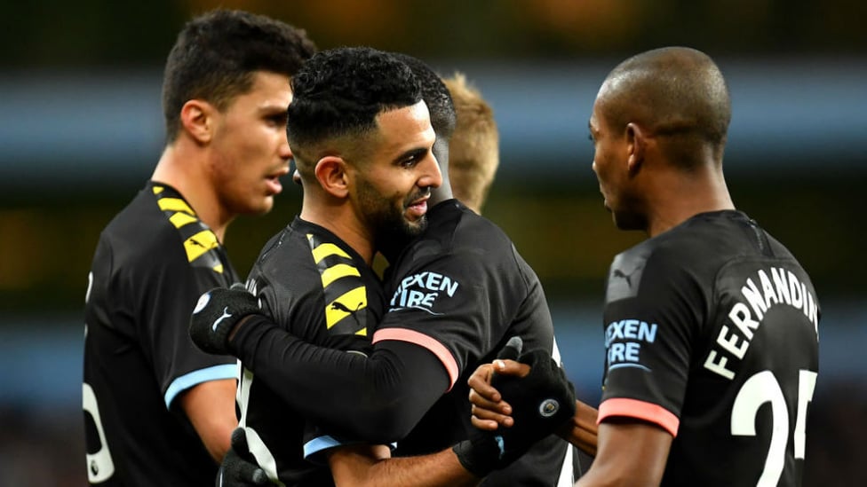 DOUBLE DELIGHT : Riyad Mahrez is mobbed after his second goal of the afternoon