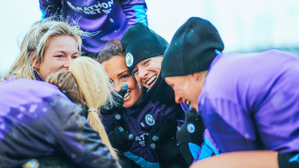 PURPLE PATCH : The players huddle together for warmth!