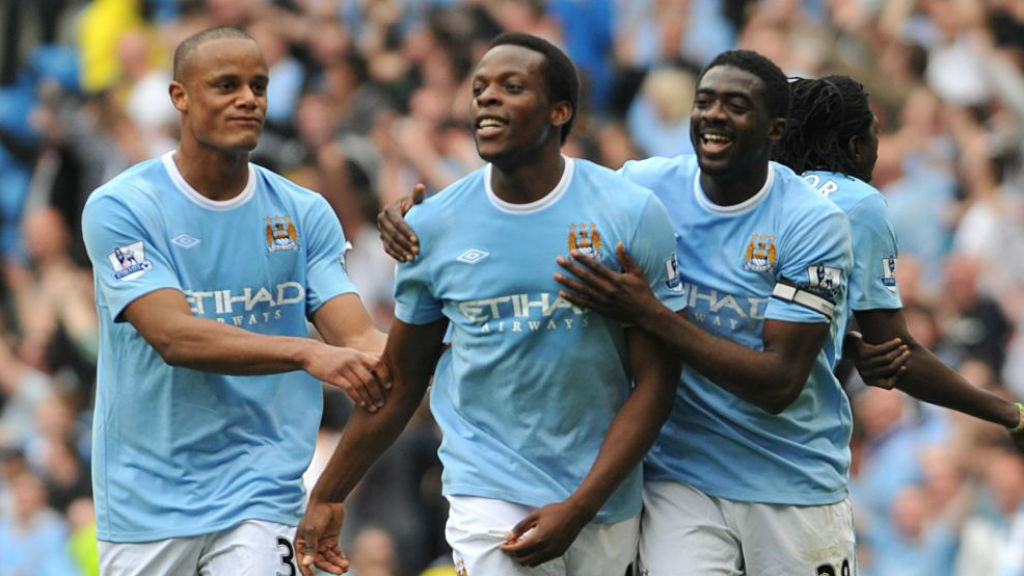 ALL SMILES: Nedum Onuoha celebrates a City goal with Vincent Kompany and Kolo Toure