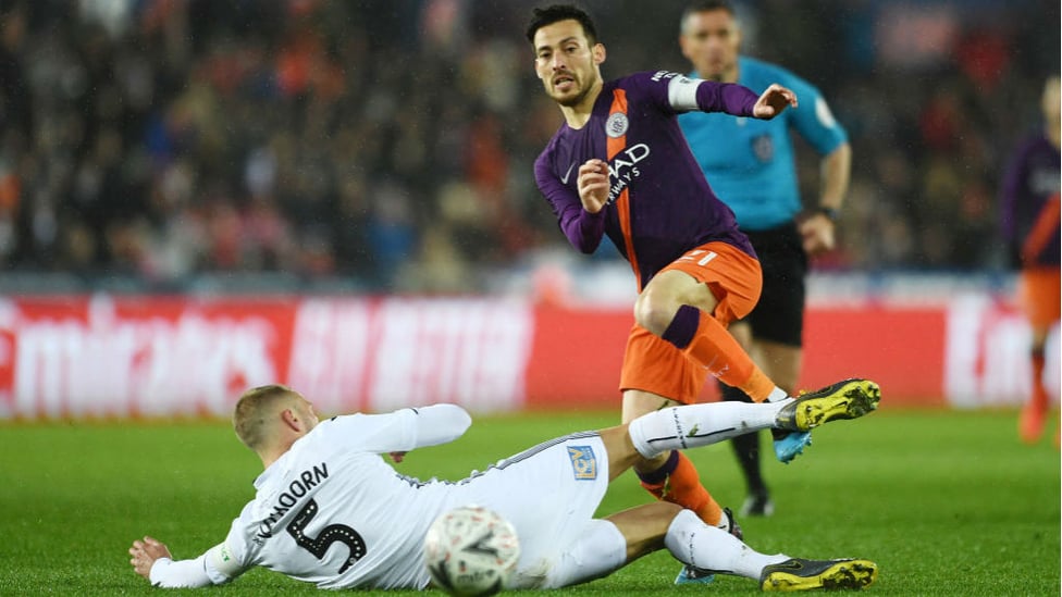 SKIP TO IT : David Silva evades the challenge of Swansea's Mike van der Hoorn