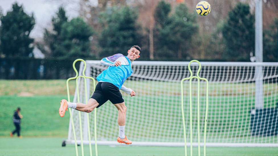 ON THE UP : Phil Foden leaps for a header