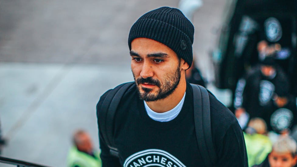 HATS THE WAY TO DO IT : Ilkay Gundogan had his game face on he boarded the plane