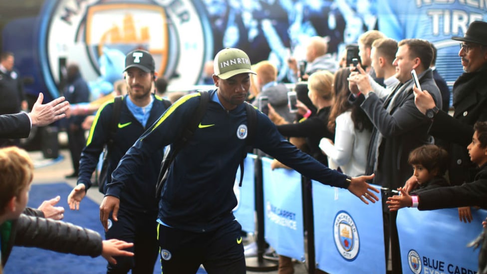 HATS THE WAY TO DO IT : The fans greet Fernandinho and David Silva as City arrive at the Etihad