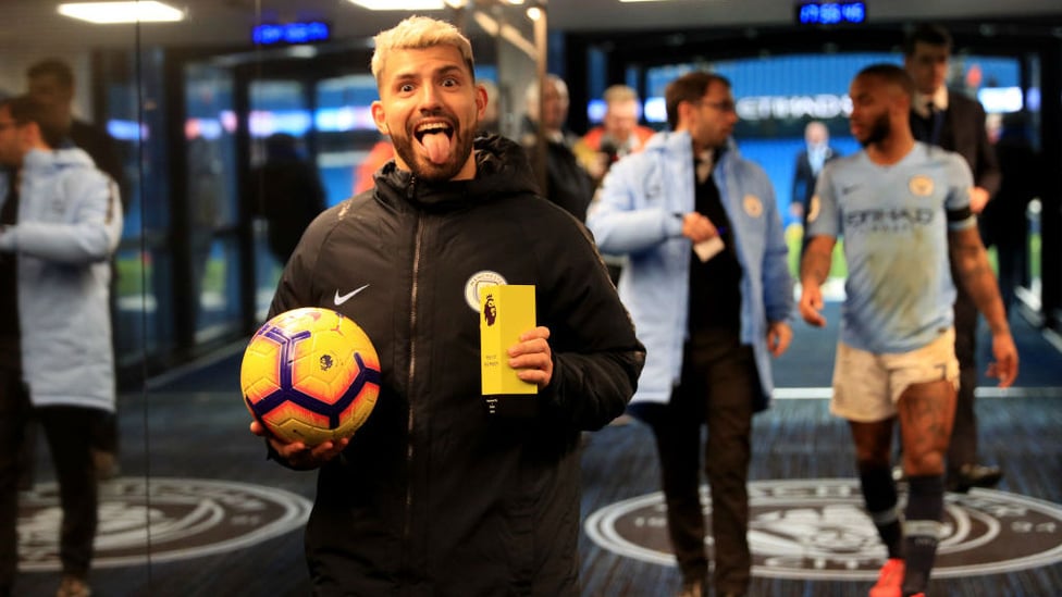 PRIZE GUY : Kun clutches the match ball and man of the match award after his second treble in a week - this time against Chelsea, seven days on from his Etihad exploits against Arsenal