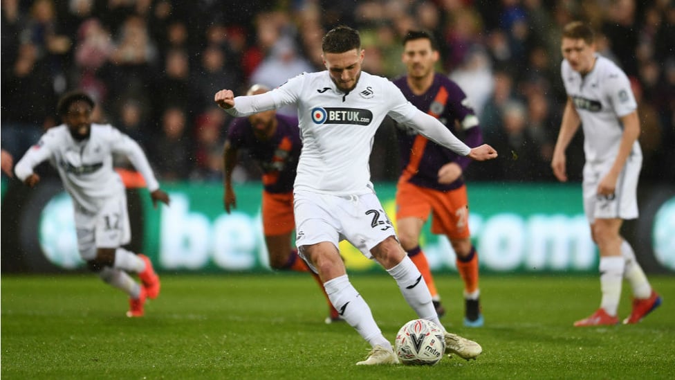 BLOW : Matt Grimes converts the spot-kick to give Swansea the lead