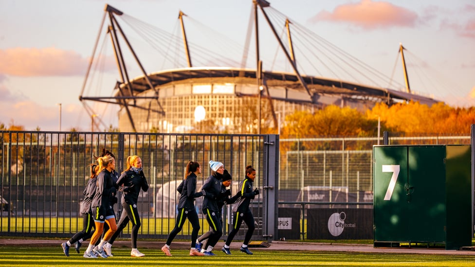 BACKDROP GOALS : The sun hits the Etihad Stadium in the background