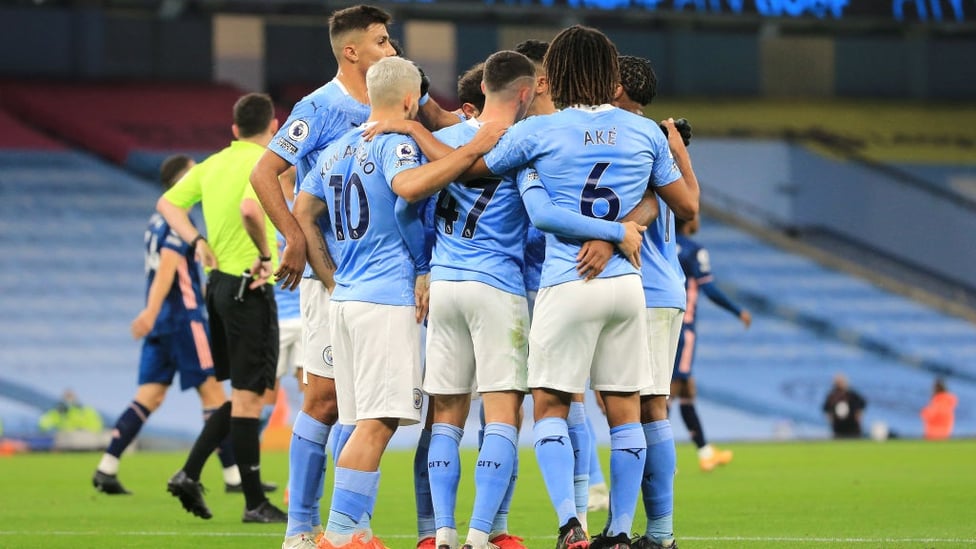 GROUP HUG : The players gather to celebrate Sterling's opener in the 23rd minute.