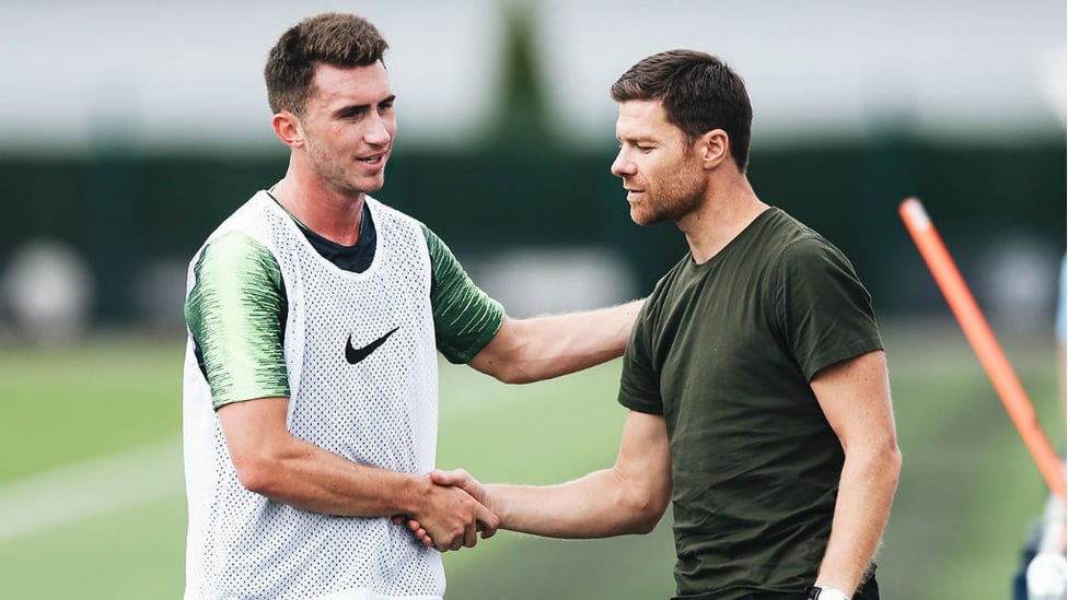 X FACTOR : Spanish legend Xabi Alonso, who played under Pep Guardiola at Bayern Munich was at the CFA today and here exchanges greetings with Aymeric Laporte