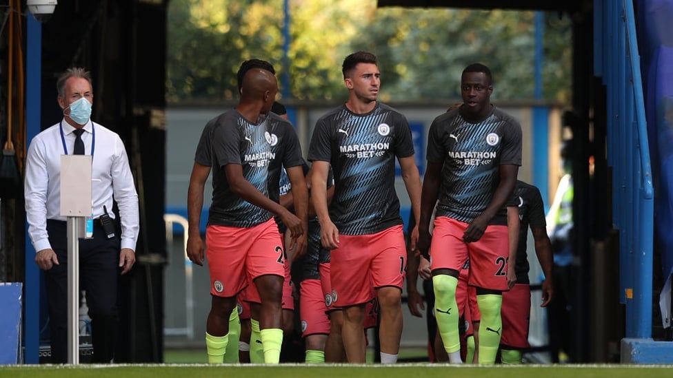 ARRIVAL : Mendy and co walk out onto the pitch to warm up.