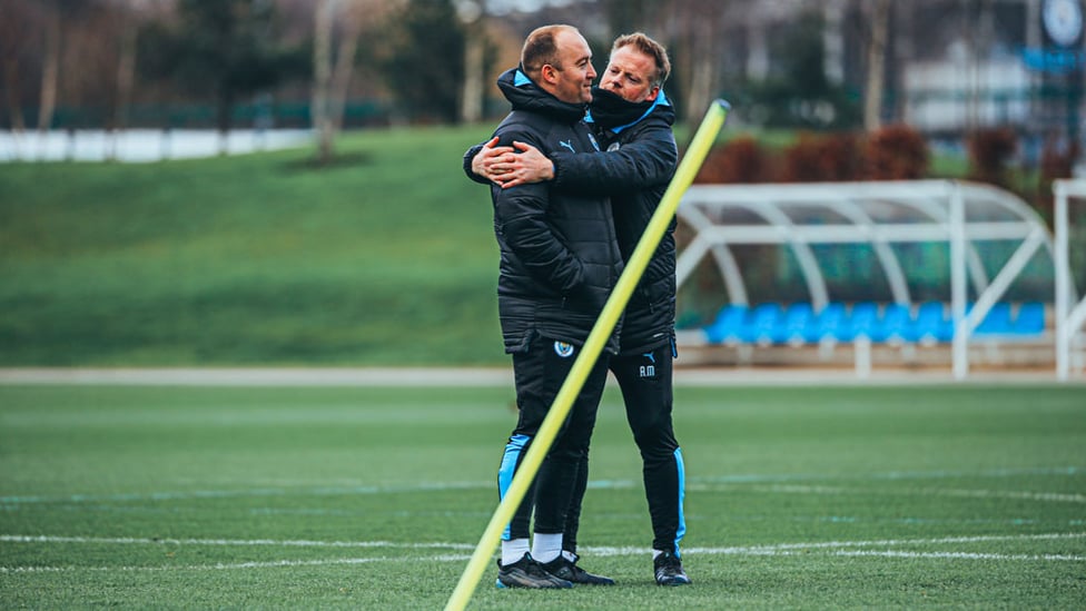 A FOND FAREWELL : Assistant manager Alan Mahon embraces the boss ahead of Saturday's session