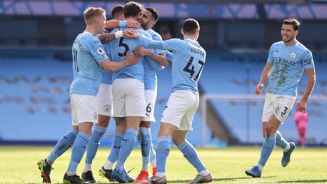 GROUP HUG: The players gather to congratulate Stones after his fourth goal in all competitions this season.