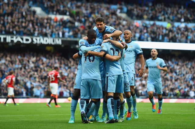 Manchester City celebrate after scoring against Manchester United