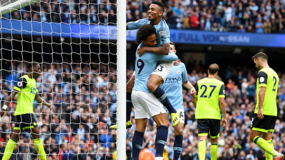 HIT FOR SIX : Gabriel Jesus and Leroy Sane celebrate one of City's six goals against Huddersfield Town