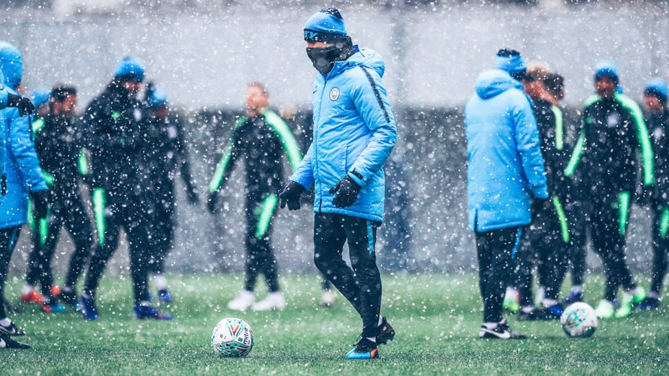 SNOW PATROL : Boss Pep Guardiola keeps out the snow showers as he oversees Tuesday's training session