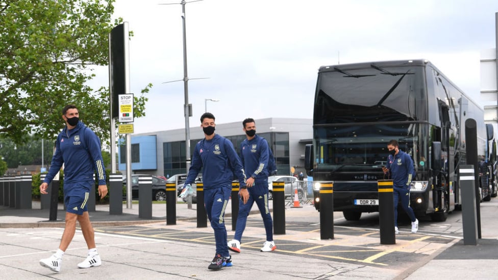 SAFETY FIRST: Members of the Arsenal squad arrive wearing protective face masks