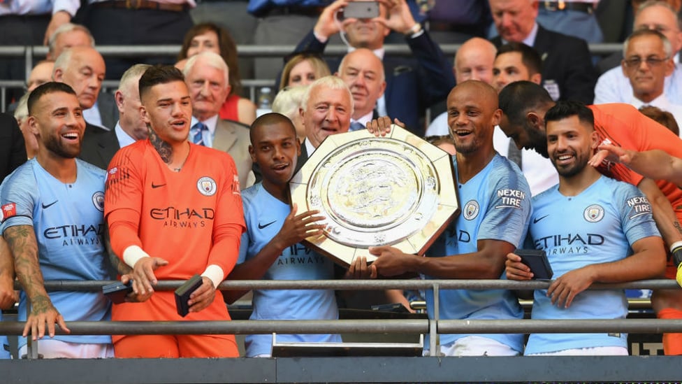 HEAT SHIELD : Ferna proudly lifts the Community Shield aloft with Vincnet Kompany after our 2-0 win over Chelsea in 2018