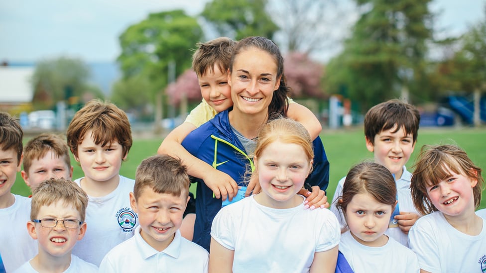 SMILES : The kids enjoyed practising their football skills with Tess