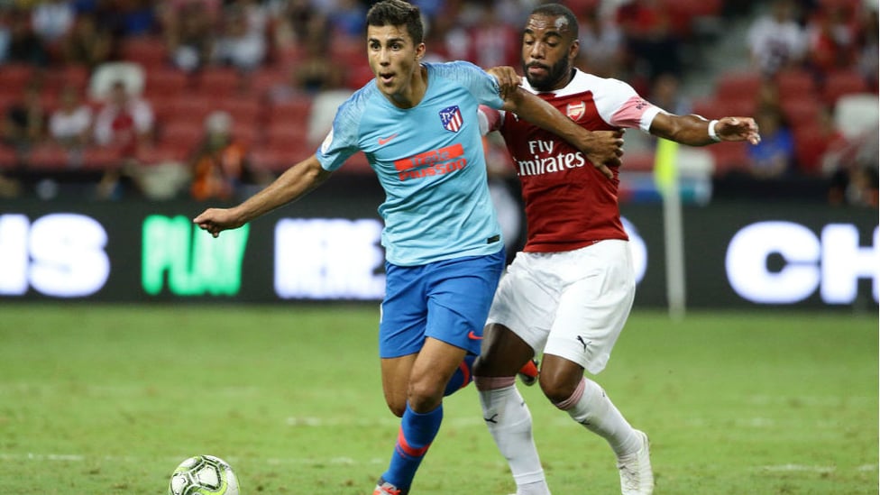 NEW START : After making the move to Atletico Madrid last summer, Rodri is seen in action against Arsenal's Alexandre Lacazette in last summer's Intedrnational Champions Cup event