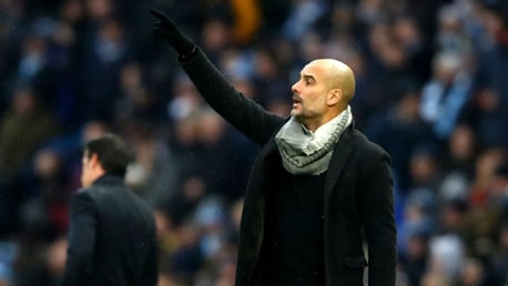 GLOVE STORY: Pep Guardiola is well wrapped up as he fires out instructions