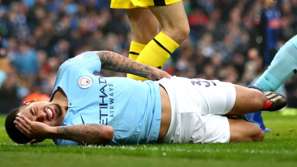 OUCH : Gabriel Jesus winces in pain after an early collision