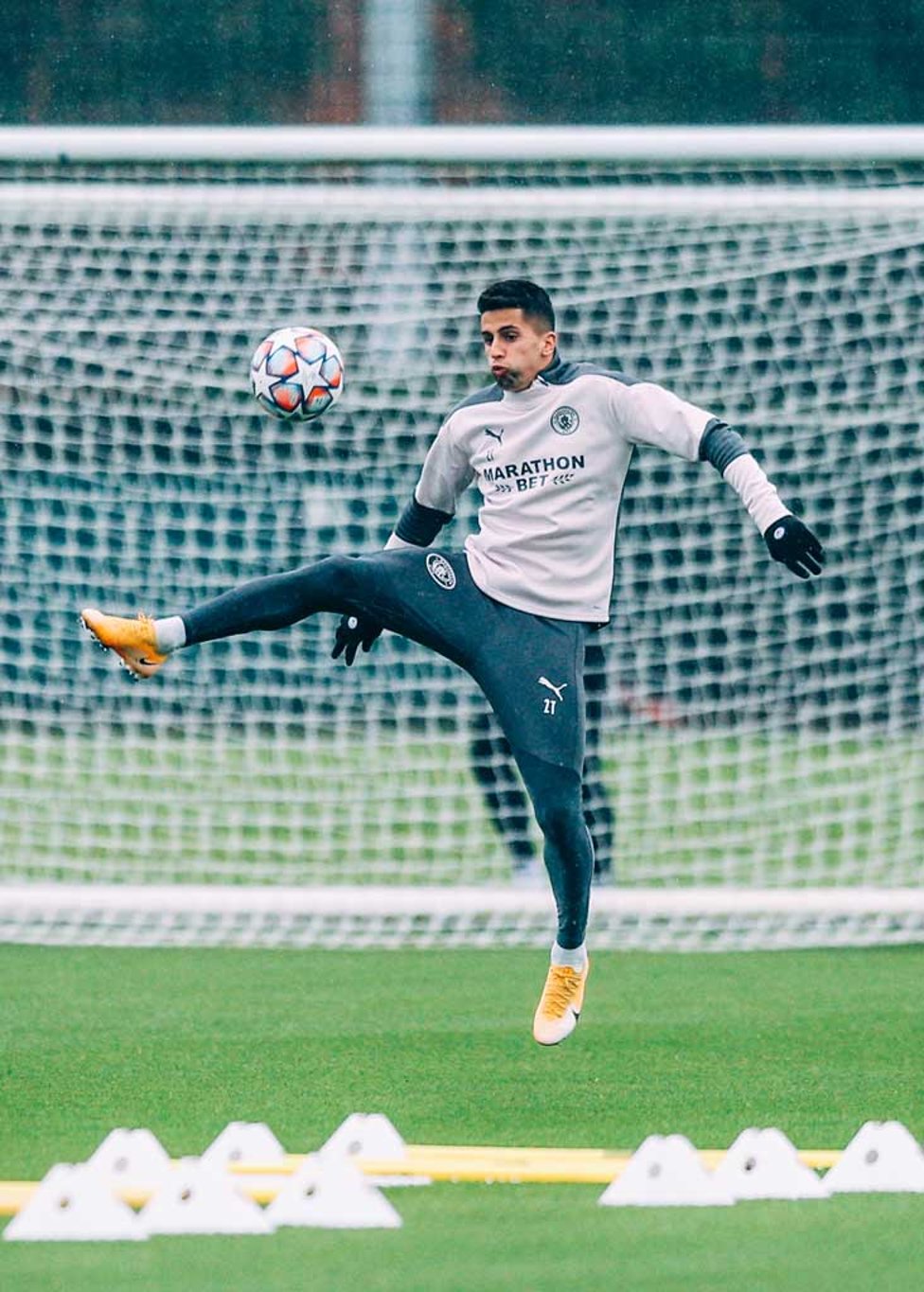 Joao Cancelo brings the ball down 