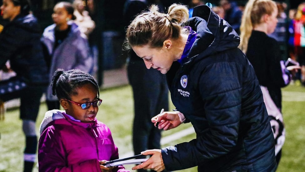 STARSTRUCK A young attendee gets a priced autograph from Ellen White